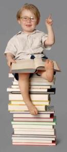 boy on book stack CROP COMP